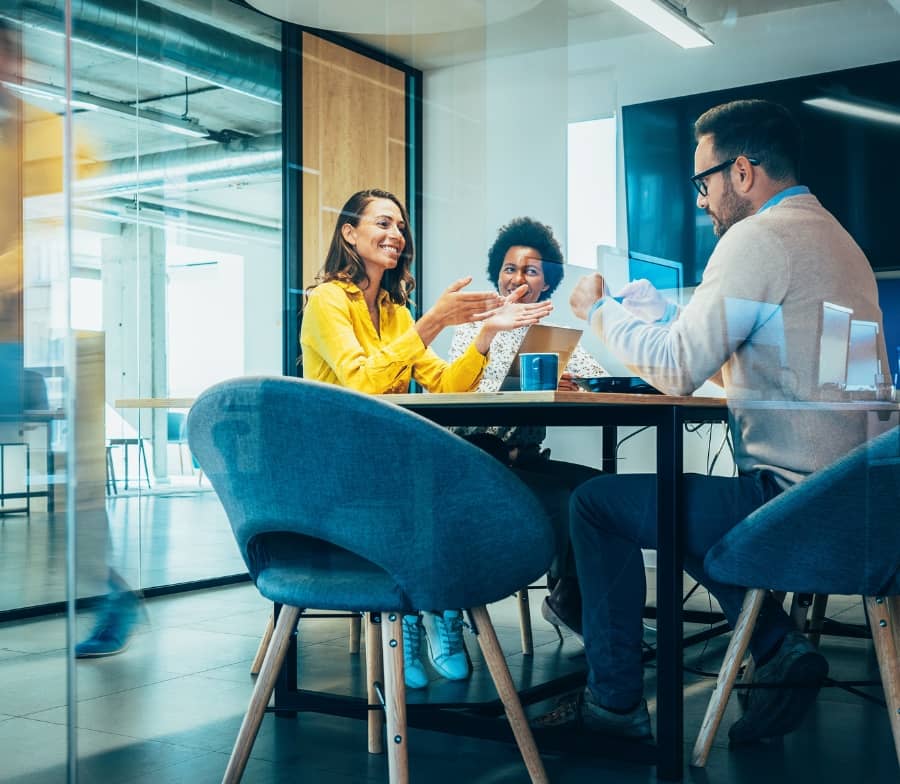 Acutest employees work at a desk with client